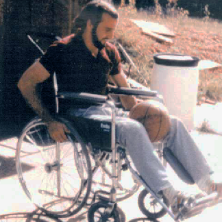 a picture of Doug in a wheelchair from several years ago.