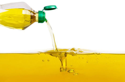 Vegetable oil pouring on vegetable oil background