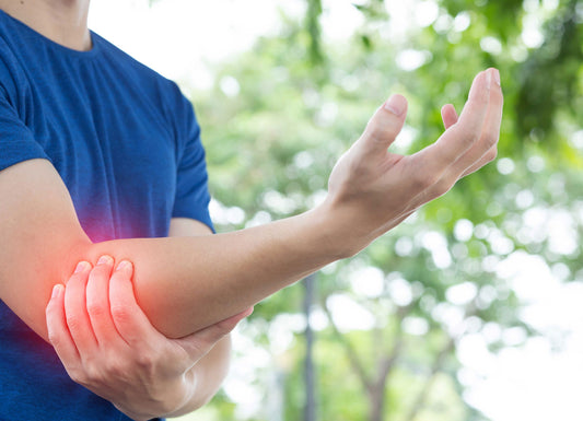 Zoomed in picture of a person holding their elbow. Where the hand holds the elbow, there is a red glow effect to show pain. Acute Pain & Inflammation