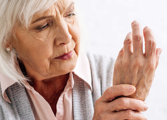 Elderly woman looking at her hand with concern Autoimmunity