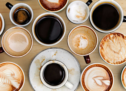 Several coffee mugs, some filled, some empty and stained. Caffeine Addiction