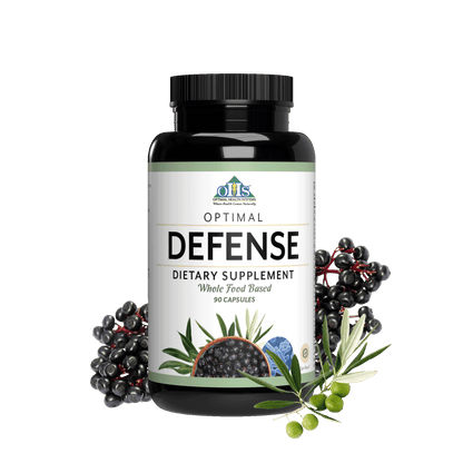 Image of a bottle of Optimal Defence. Around the bottle is a picture of a bunch of elderberries, an olive branch with green olives, and a bowl of anise seed.